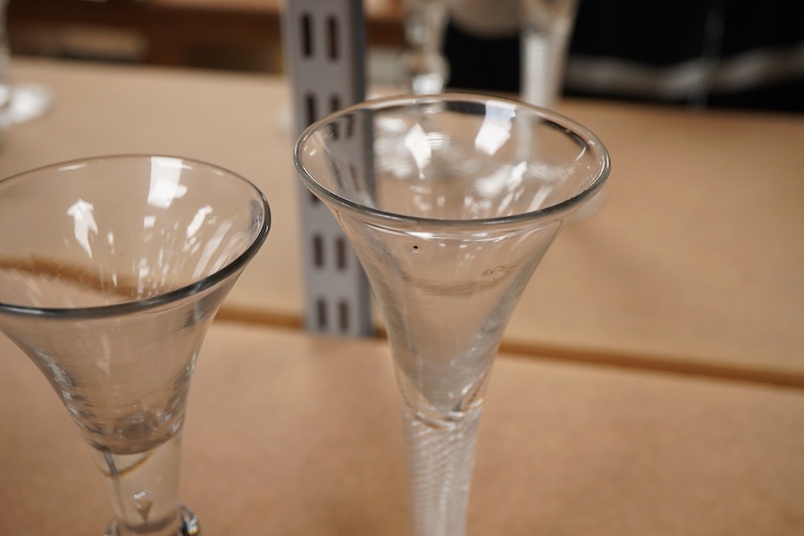 Three 18th century trumpet glasses, two with air twist stems (one with folded foot), together with another with a knopped stem and tear, tallest 16.5cm high